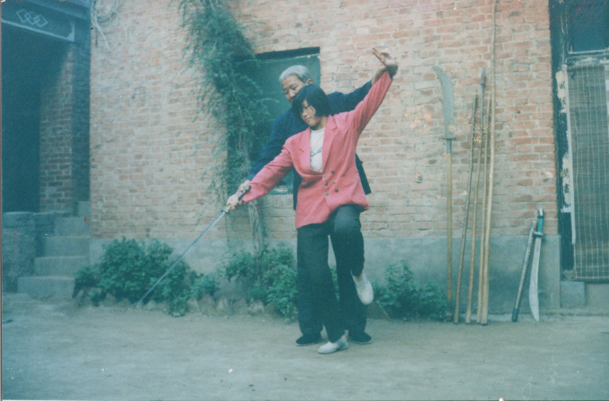 Chen Chunlei guiding his daughter Chen Huixian in straight-sword form